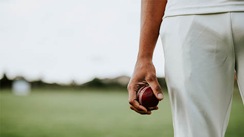 cricketer holding a ball